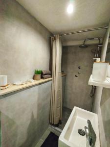 a bathroom with a sink and a shower at Apartman Monroe in Sarajevo
