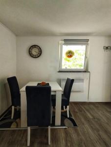 a dining room with a table and chairs and a window at Apartman Monroe in Sarajevo