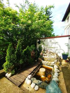a garden with a pond with rocks and trees at Apartman Monroe in Sarajevo