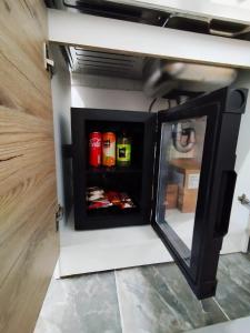 a small refrigerator in a kitchen with its door open at Apartman Monroe in Sarajevo