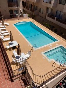 an overhead view of a swimming pool with lawn chairs and anophe at Catalina's Got Cart Condo in Avalon +10 photos