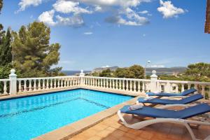 a swimming pool with two lounge chairs next to it at Villa Monsita by Slow Villas in Santa Ponsa