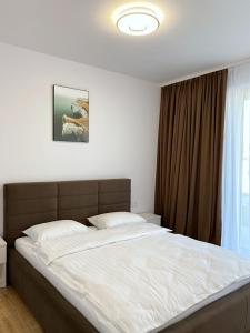a bedroom with a large bed in front of a window at Apartamenty Przemyśl BG in Przemyśl
