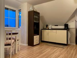 a kitchen with a counter and a table in a room at Zur Mühle Lemkenhafen auf Fehmarn in Fehmarn