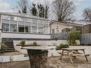 a table and a picnic table in front of a house at 2 Carlton Cottage in Enniskillen