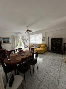 a living room with a table and chairs and a couch at Ioanna D in Tolo