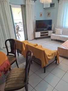 ein Wohnzimmer mit einem Tisch mit einer Decke darauf in der Unterkunft Kostas' House luxury apartment near Volos center in Volos
