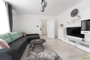 a living room with a couch and a table at Iggy Premium Apartment in Hunedoara