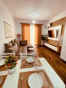 a living room with a table and a couch at Laurent's Durres sea apartment in Durrës