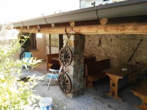 a patio with a stone fireplace with a wooden roof at Appartamenti Casa rita - Ap 1 Gardasee in Tremosine Sul Garda