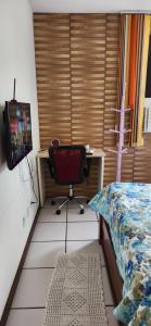 um quarto com uma secretária e uma cadeira ao lado de uma cama em EDIFÍCIO METROPOLE ONDINA em Salvador