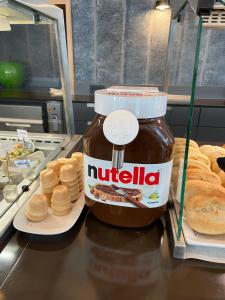 a jar of nutella sitting on a counter with bread at Median Hotel Hannover Messe in Hannover