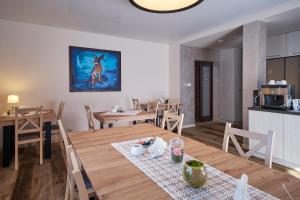 kuchnia i jadalnia ze stołem i krzesłami w obiekcie Dom Gościnny Wetlinn w Wetlinie