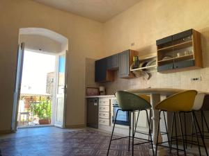 a kitchen with a table and chairs in it at Apollo in Orosei
