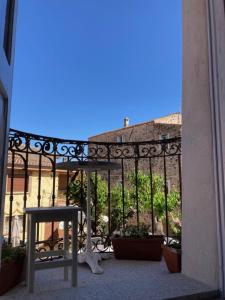 a balcony with a fence and plants in a building at Apollo in Orosei