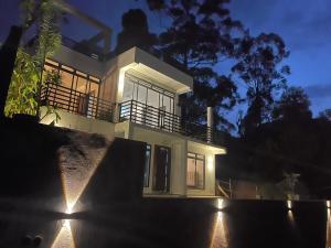 a house with lights in front of it at night at Hanthana Heritage in Kandy