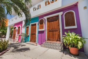 a colorful house with wooden doors at Hotel Gran Juquila Huatulco in Santa Cruz Huatulco