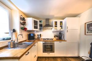 a kitchen with white cabinets and a sink at Studio Garibaldi 7 in Verona