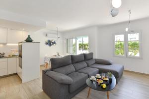 a living room with a couch and a table at Marina Port 15 by VillaGranCanaria in Pasito Blanco