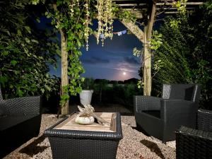 a patio with chairs and a table with a view at B&B De nieuwendijk in Zuid-Beijerland