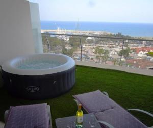 a hot tub on a balcony with a view at Aphrodite Heights in Larnaka