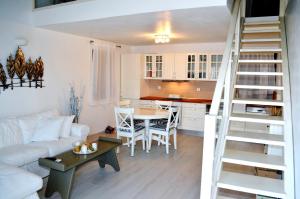 a living room and kitchen with a white couch and a table at Villa Aristoteles in Halki +24 photos
