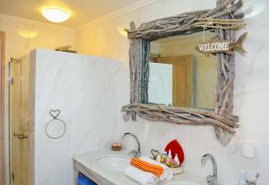 a bathroom with a sink and a mirror at Villa Aristoteles in Halki