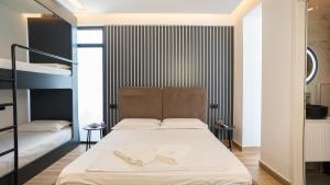 a bedroom with a bed with two books on it at Azure Sea View Apartments in Durrës