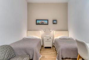 A bed or beds in a room at Manto Hotel