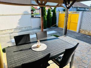 a wooden table and chairs on a patio at Kuća za odmor Šimun in Vukovar +9 photos