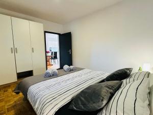 a bedroom with a large bed with two pillows at Kuća za odmor Šimun in Vukovar
