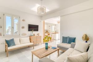 a living room with two couches and a table at Paros Sea View Eco - Aetherian Ciel Villas, Niso in Mármara