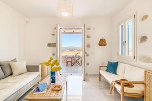 a living room with a couch and a table at Paros Sea View Eco - Aetherian Ciel Villas, Niso in Mármara