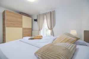 a bedroom with two beds with a teddy bear on them at Apartman Toni in Krk