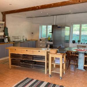 a kitchen with a counter and a table in it at Kolarbogård in Fors