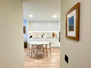 a kitchen and dining room with a table and chairs at BPIRINEOS-Besurta in Benasque +9 photos
