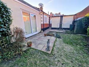 a backyard with a statue of a cat in the yard at 3 Harbord road in Cromer