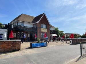 a building with tables and chairs in front of it at 62 M&T Chalets , 2 bed detached chalet Florida holiday park Hemsby in Hemsby