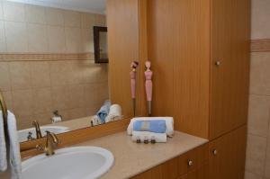 a bathroom with a sink and a mirror at Villa Blu Majestic beach villa in Halki