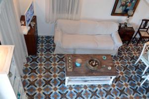 a living room with a couch and a table at Villa Blu Majestic beach villa in Halki