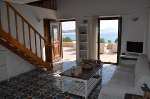 a living room with a couch and a table at Villa Blu Majestic beach villa in Halki