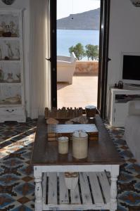 a living room with a table and a view of the ocean at Villa Blu Majestic beach villa in Halki