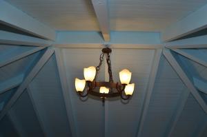 a chandelier hanging from a ceiling in a room at Villa Blu Majestic beach villa in Halki