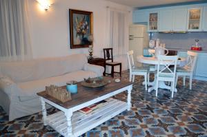 a living room with a couch and a table at Villa Blu Majestic beach villa in Halki