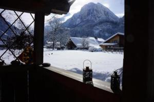 a window with a view of a snow covered mountain at Darioli 5-Bettwohnung - b48641 in Innertkirchen
