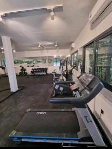 a gym with a row of treadmills and machines at Studio de luxe à casa finance city in Casablanca