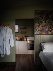 a bedroom with a white robe hanging on a wall at Wild Hideaways Luxury Lodges and Eco Spa in Bantry
