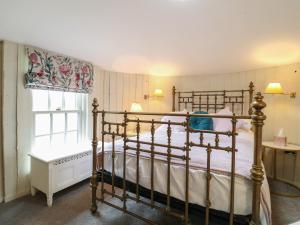 a bedroom with a bed and a window at The Lazy Squire by The Water in Rugeley
