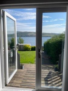 an open door to a porch with a view of the water at Tigh Na Mara in Furnace