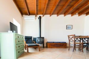 a living room with a stove and a table at Vigli House in Symi